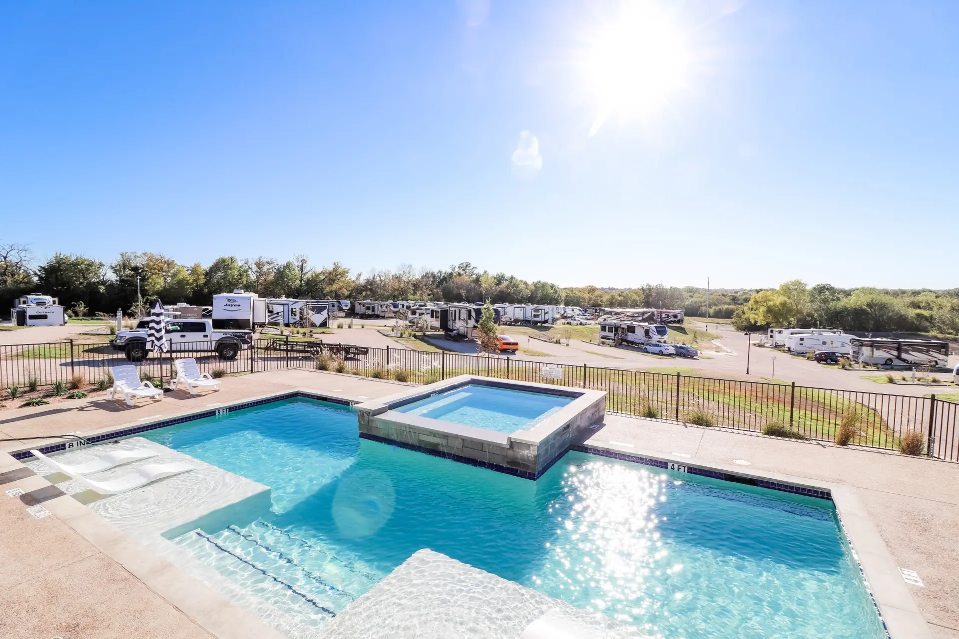 Aerial view of the heated pool, spa, and landscaped grounds — an open invitation to settle in for a longer stay at Sugar Hill.